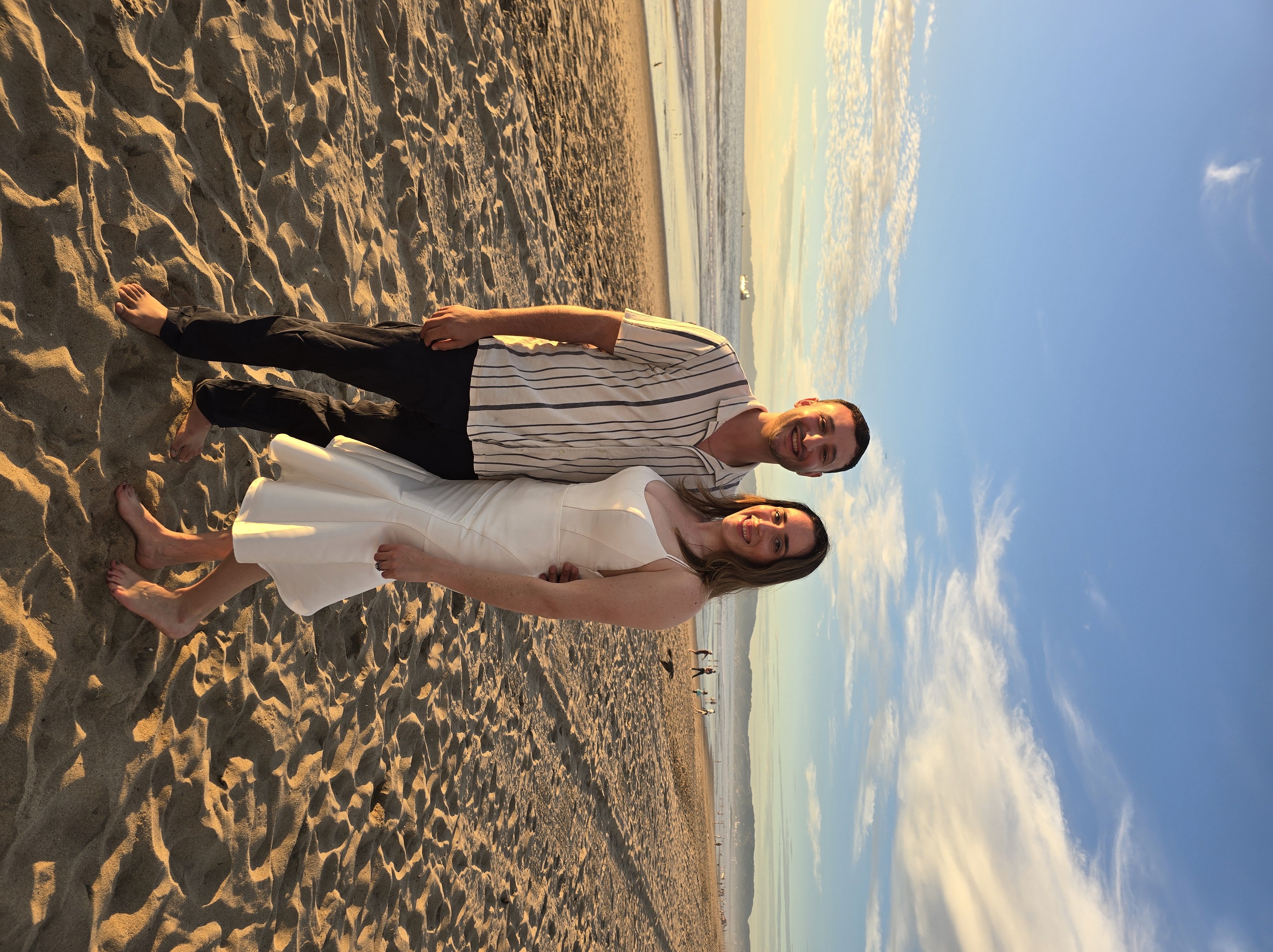 Rick and Nina barefoot on Manhattan Beach in Los Angeles at sunset